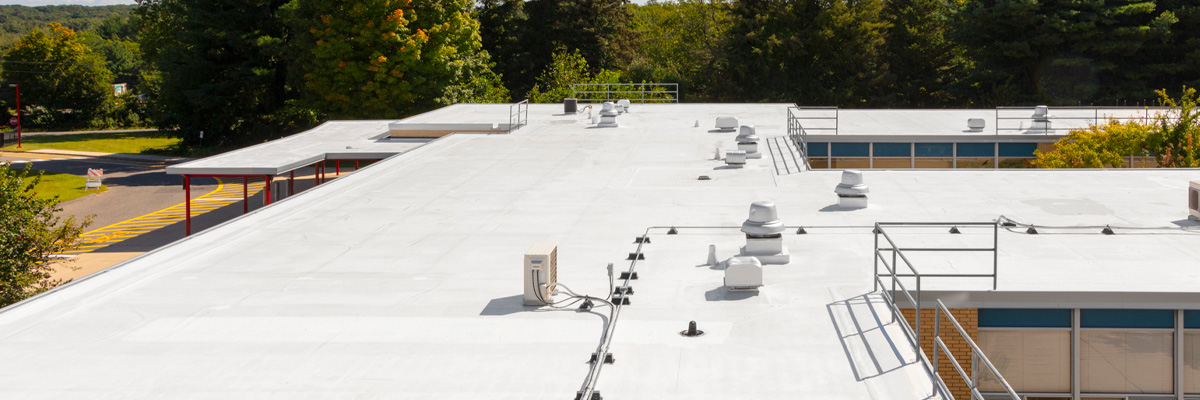 A roof with a coat of white roofing primer from Garland.